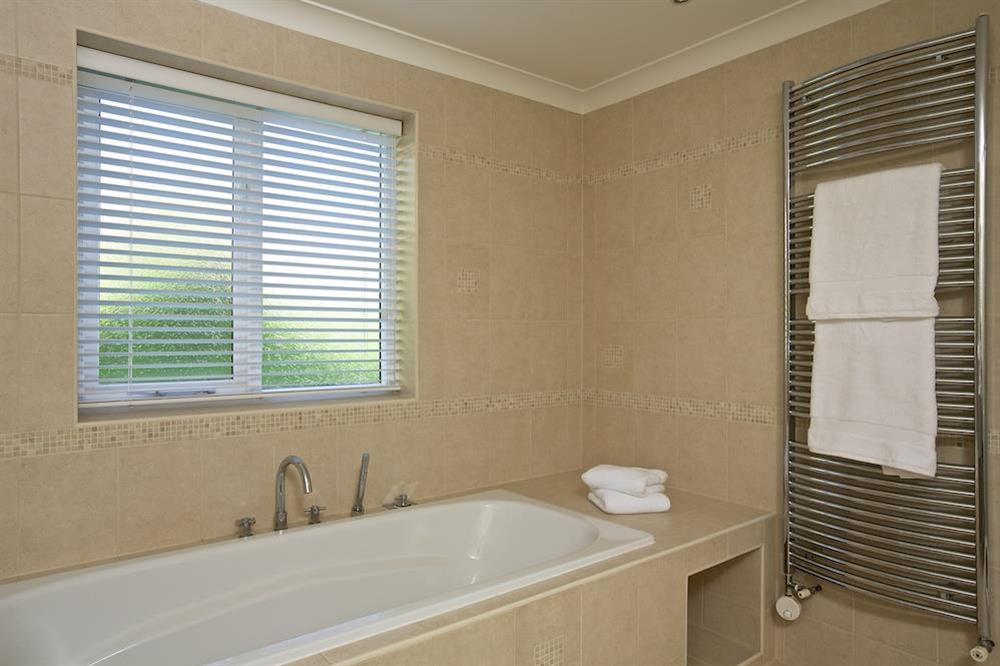 Bath and heated towel rail in the family bathroom at Spindrift in , Thurlestone