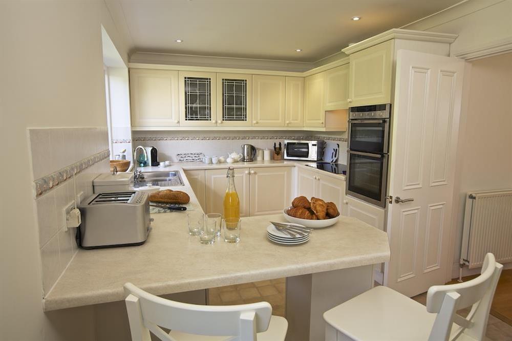 Breakfast bar with two stools at the edge of the kitchen at Spindrift in , Thurlestone