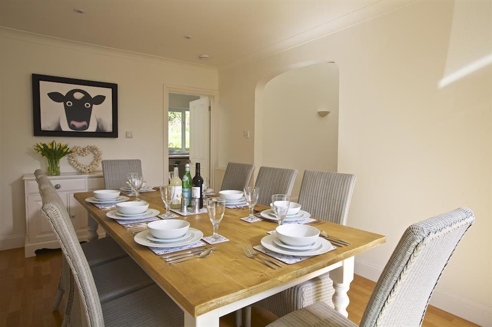 Dining room furnished with a large table and set of eight chairs at Spindrift in , Thurlestone