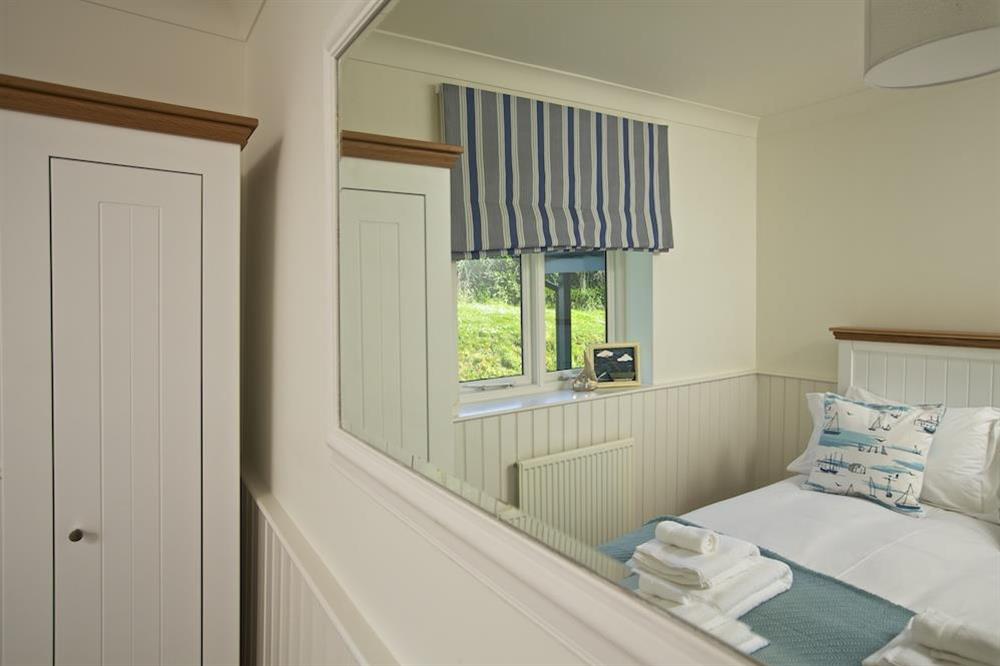Large wall-mounted mirror in bedroom at Spindrift in , Thurlestone