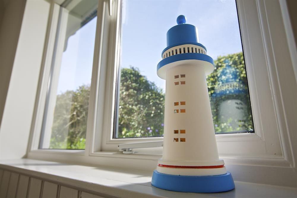 Twin bedroom window with lighthouse ornament at Spindrift in , Thurlestone