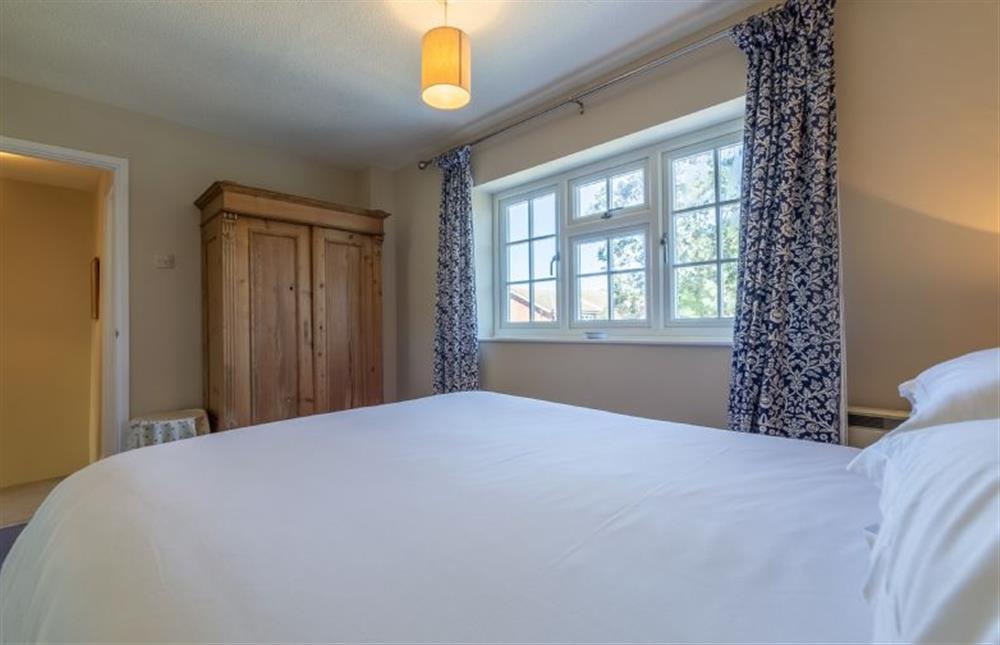 First floor: master bedroom with king-size bed  at Spinnakers, Brancaster Staithe near Kings Lynn