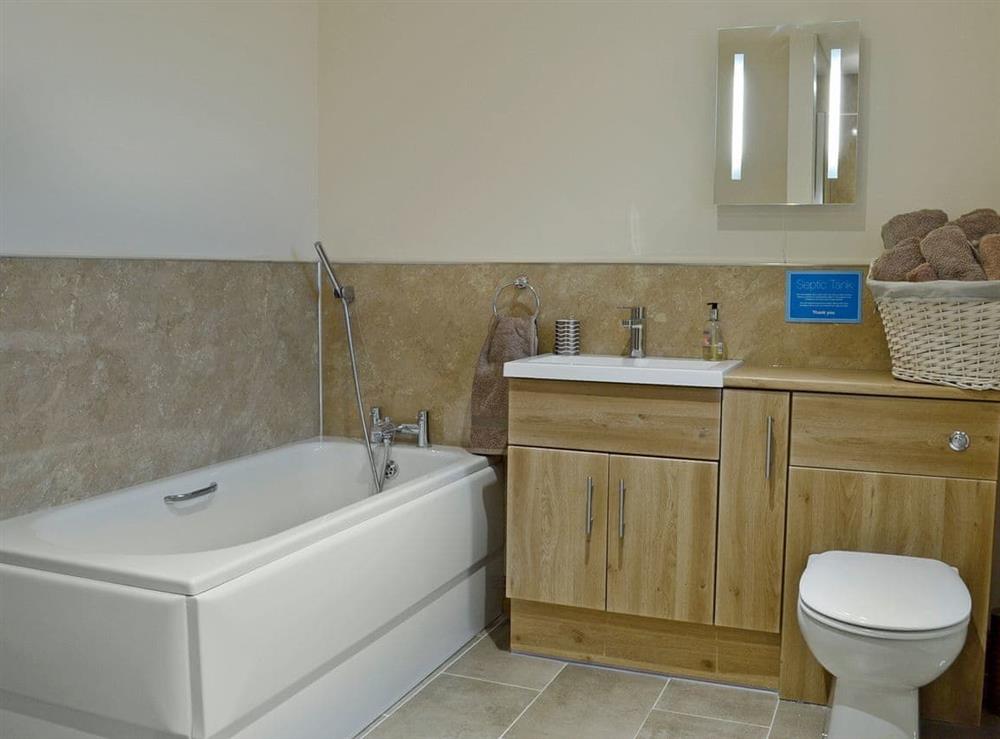 Large bathroom with separate bath and shower facilities at The Bullpen, 