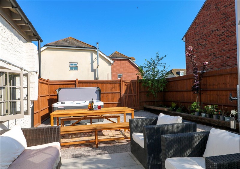 Enjoy a glass of wine on the patio at Spring Cottage, Arundel