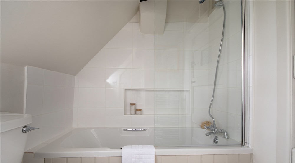 The bathroom with shower over bath at Spring Cottage in Broadway, Gloucestershire