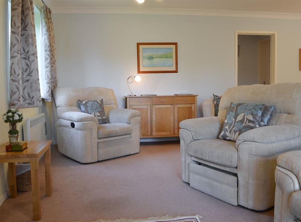Living room with dining area at Spring Mouse Apartment in Bowness-on-Windermere, Cumbria, England
