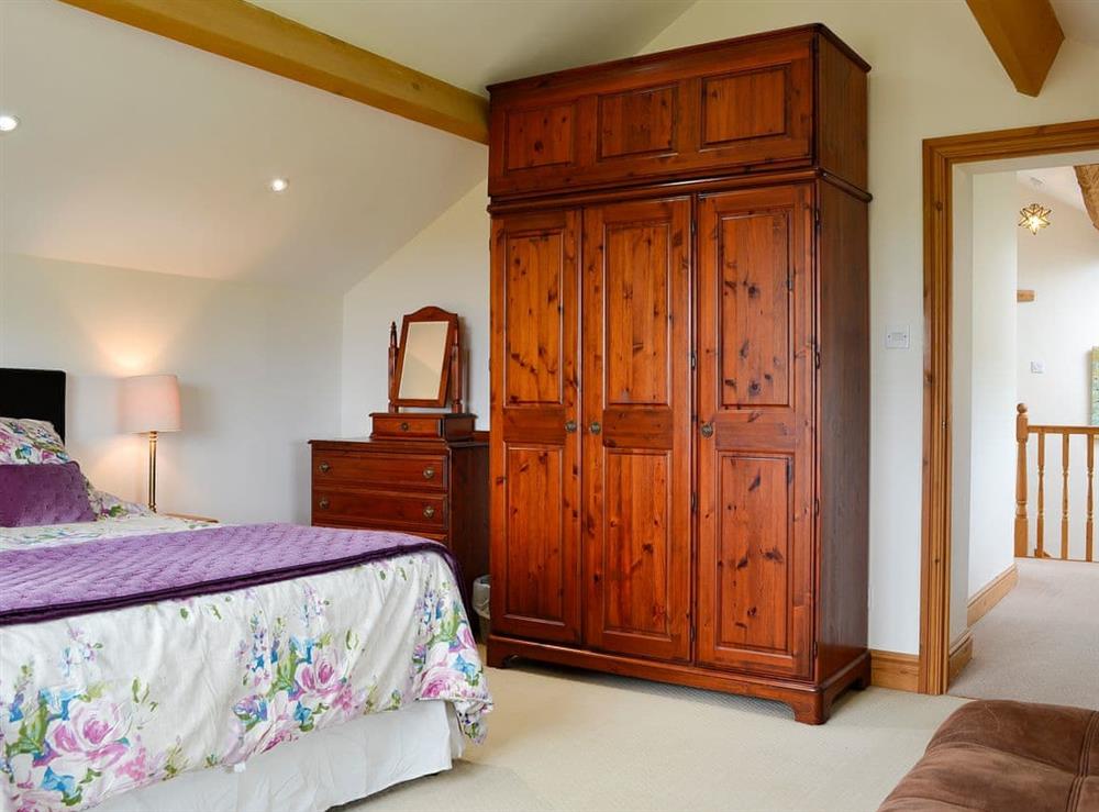 Double bedroom with exposed beams at Farm Cottage, 