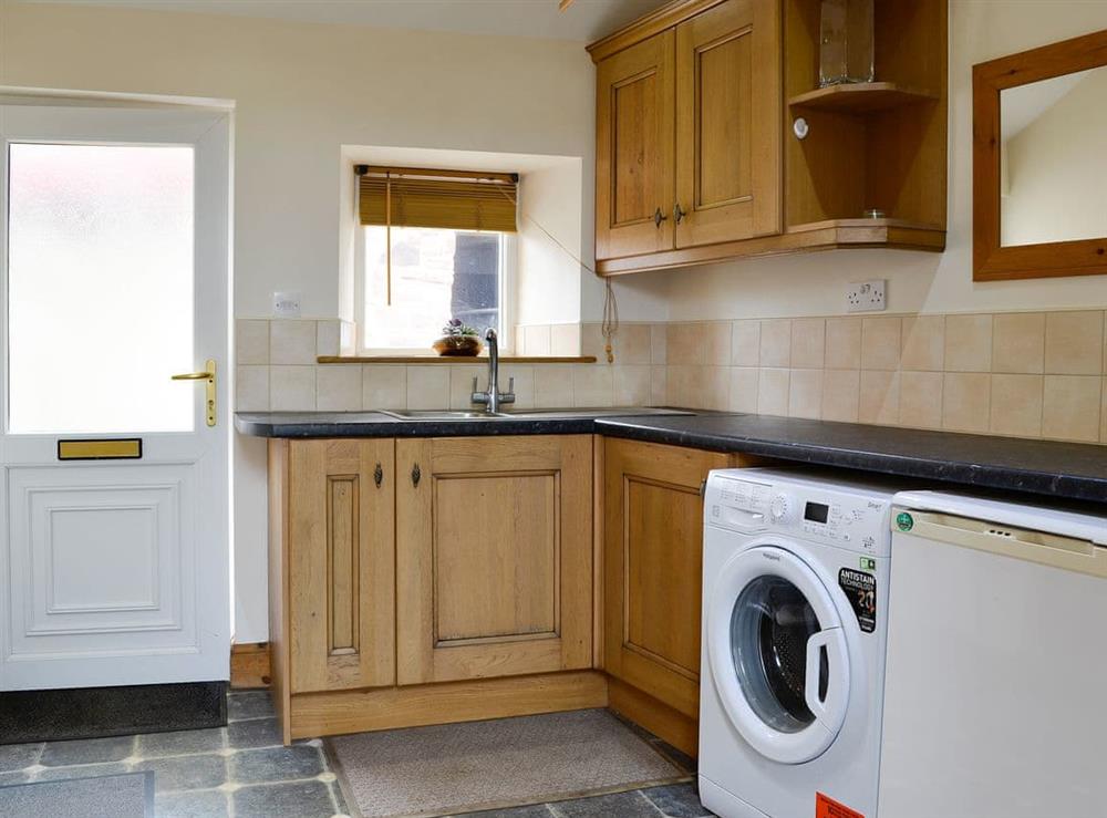 Practical utility room with laundry facilities at Farm Cottage, 