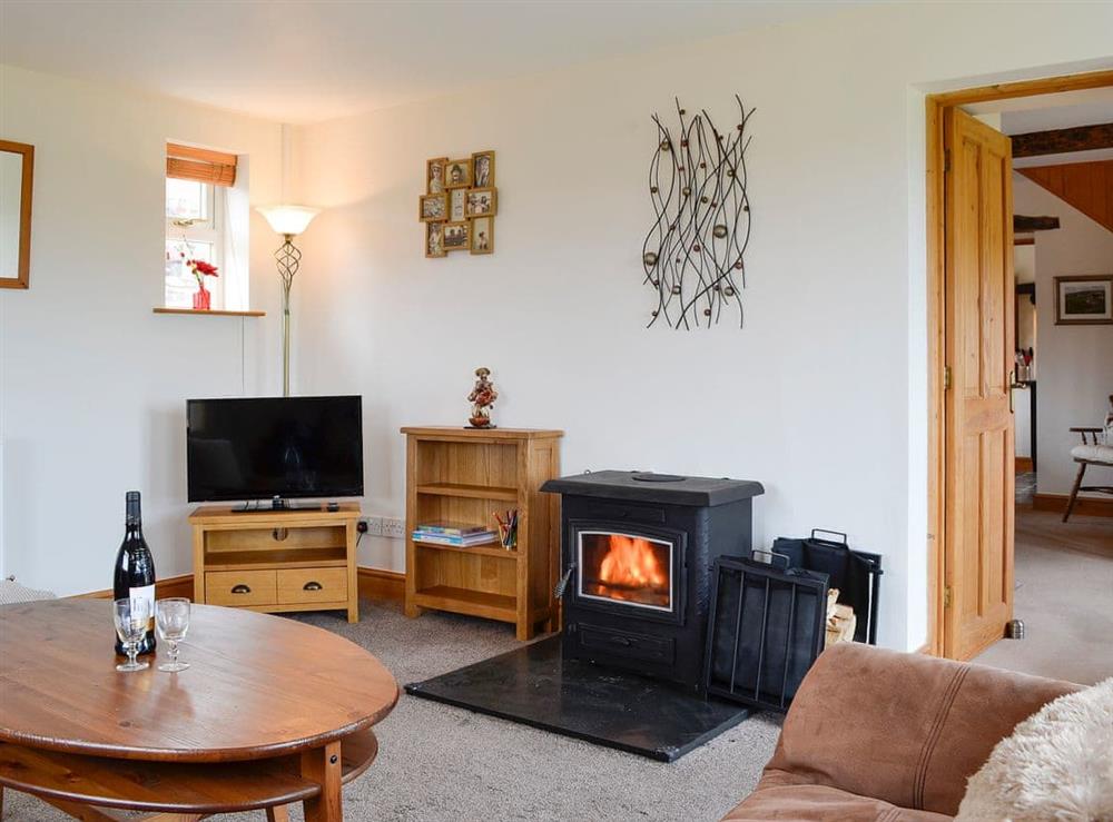 Warm and welcoming living room at Farm Cottage, 