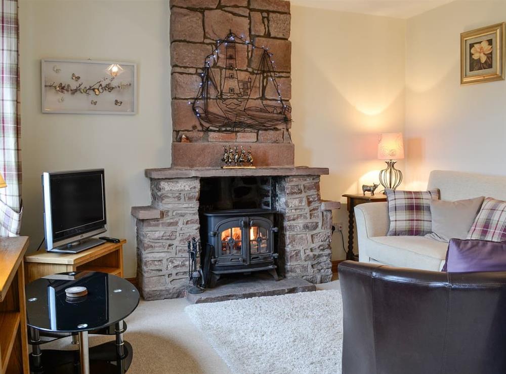 Living room with cosy wood burner at Rose Cottage, 