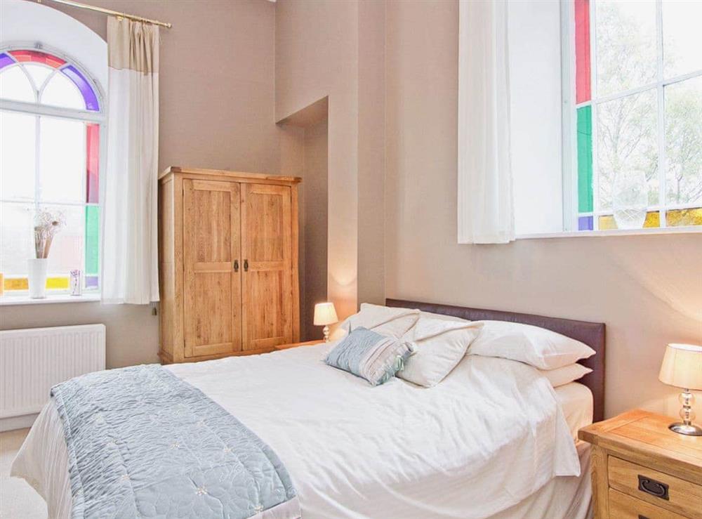 Charming double bedroom with high ceiling and stained glass windows at Springfield House in Middleton-in-Teesdale, Durham
