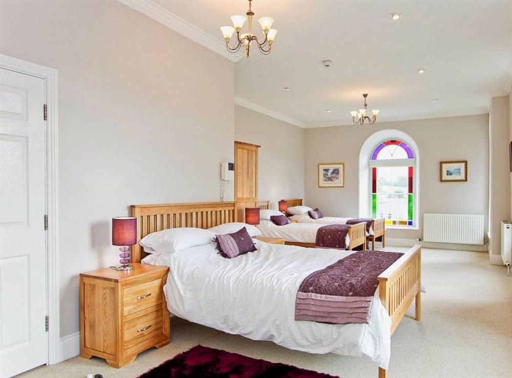 Family bedroom with en-suite shower room and feature stained glass windows at Springfield House in Middleton-in-Teesdale, Durham