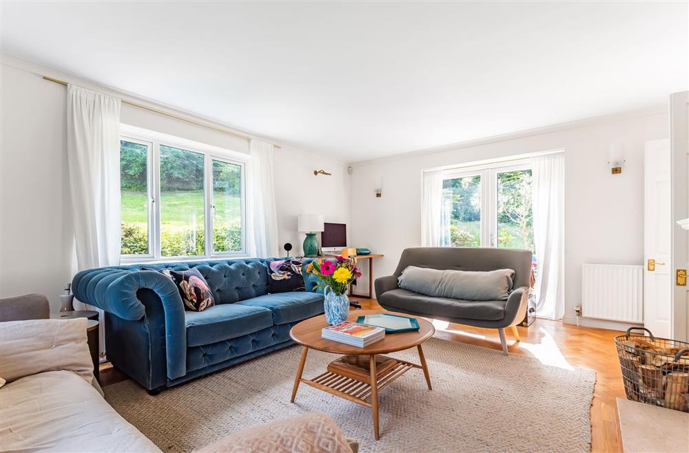 The sitting room with triple aspect windows allowing the light to flood in