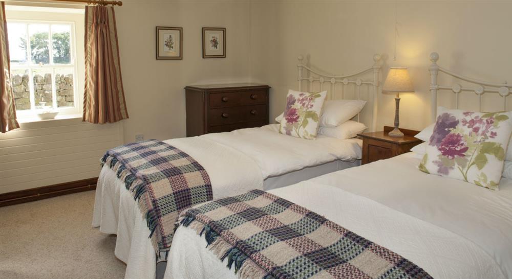 A twin bedroom at Springwell Cottage in Hexham, Northumberland