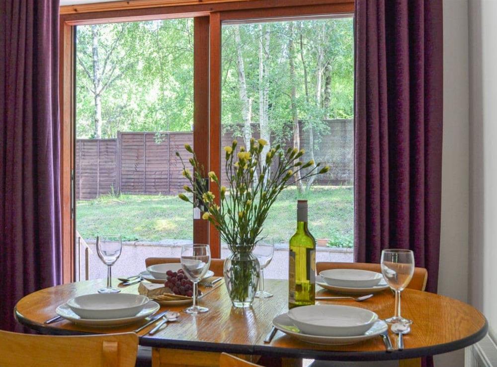 Dining area with French doors at Squirrel Cottage in North Kessock, Inverness-Shire