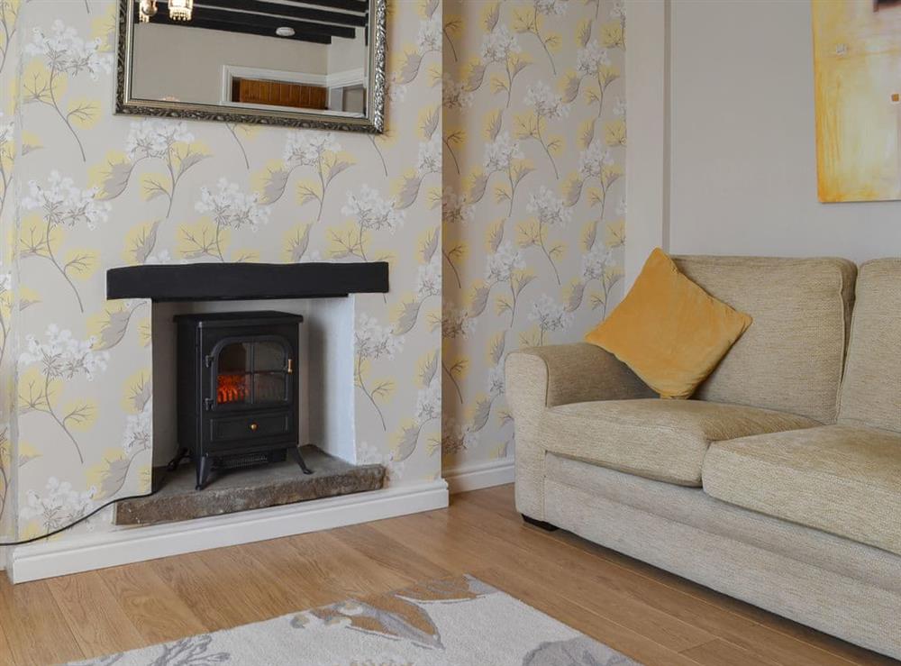 Cosy and warm living room with electric wood burner at Squirrel Cottage in Seamer, near Scarborough, North Yorkshire