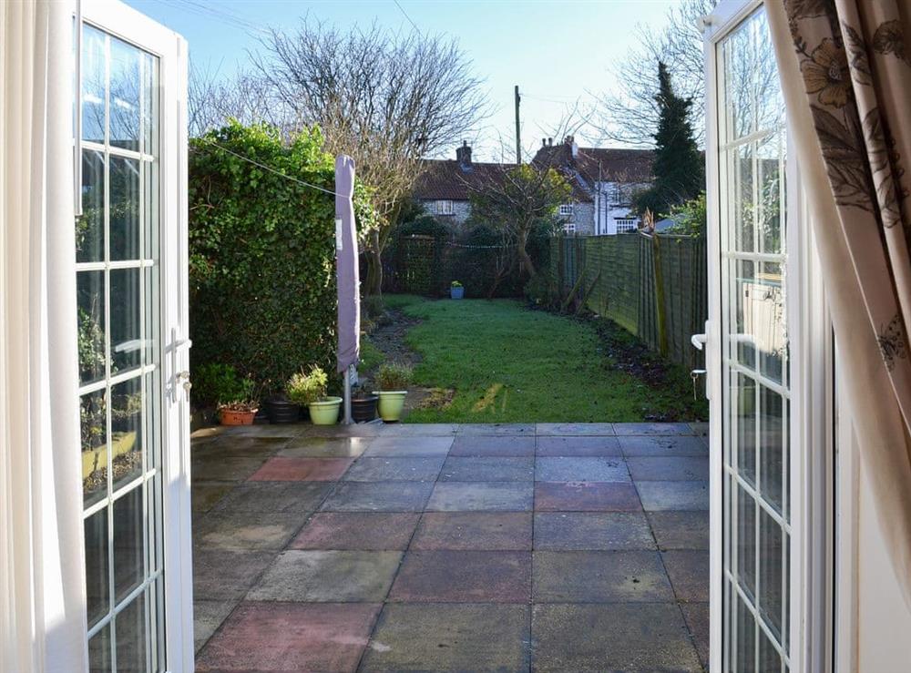 Paved patio from the double doors in the living room at Squirrel Cottage in Seamer, near Scarborough, North Yorkshire