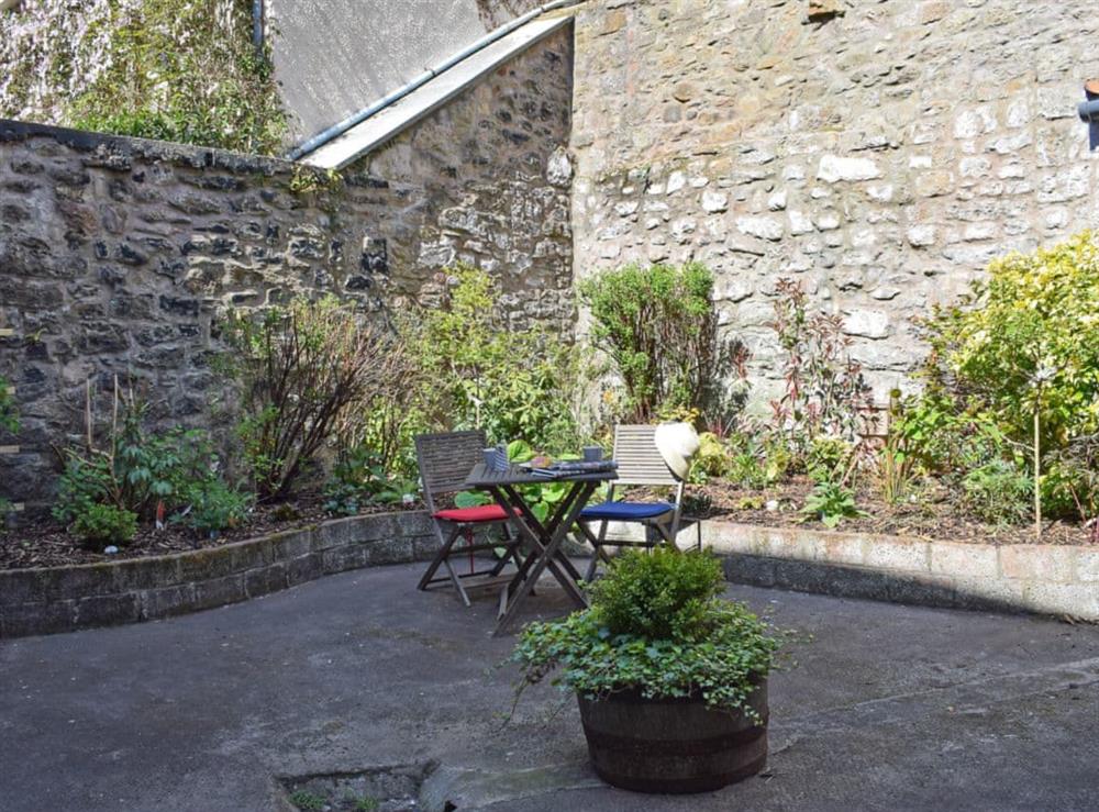Enclosed courtyard with sitting-out area with garden furniture at St Andrews in Pittenweem, near Anstruther, Fife