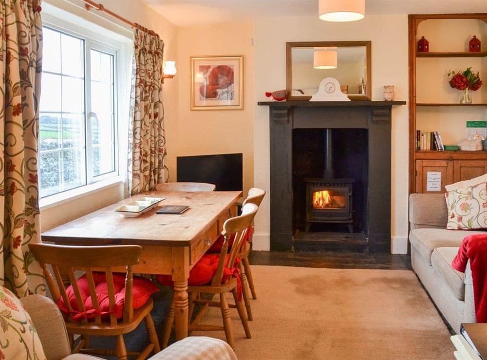 Cosy and comfortable living/dining room at St Cadoc Cottage in Harlyn Bay, near Padstow, Cornwall