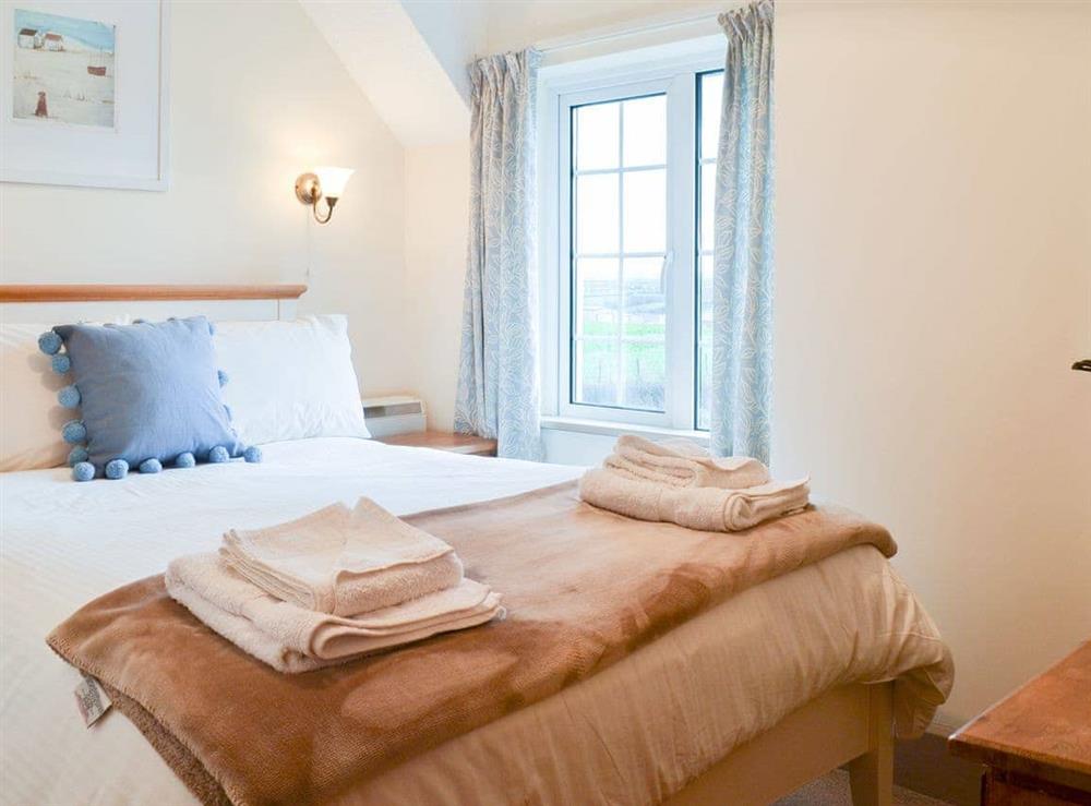 Welcoming double bedroom at St Cadoc Cottage in Harlyn Bay, near Padstow, Cornwall