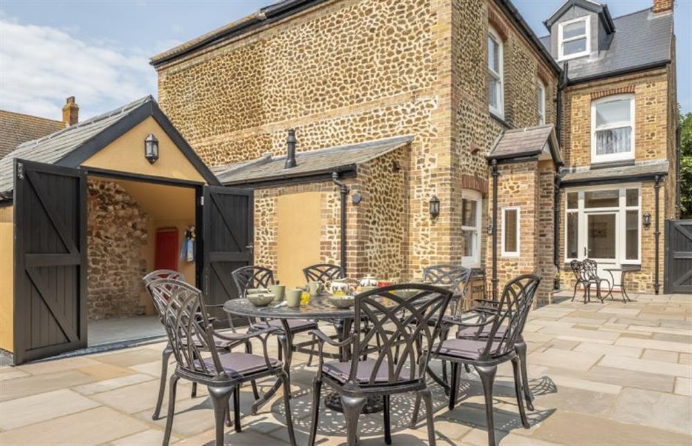 Enclosed courtyard with outdoor dining furniture and barbecue at St Edmunds View, Hunstanton