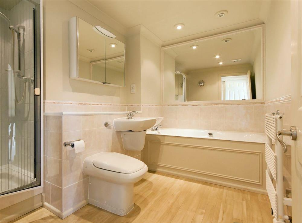 Bathroom with bath, shower cubicle, basin and WC at St Elmo Court 7 in Salcombe, Devon