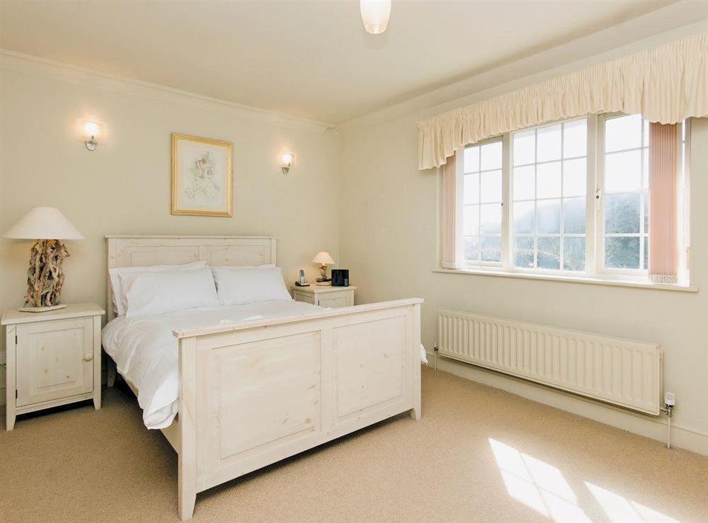 Comfortable double bedroom with door to balcony at St Elmo Court 7 in Salcombe, Devon