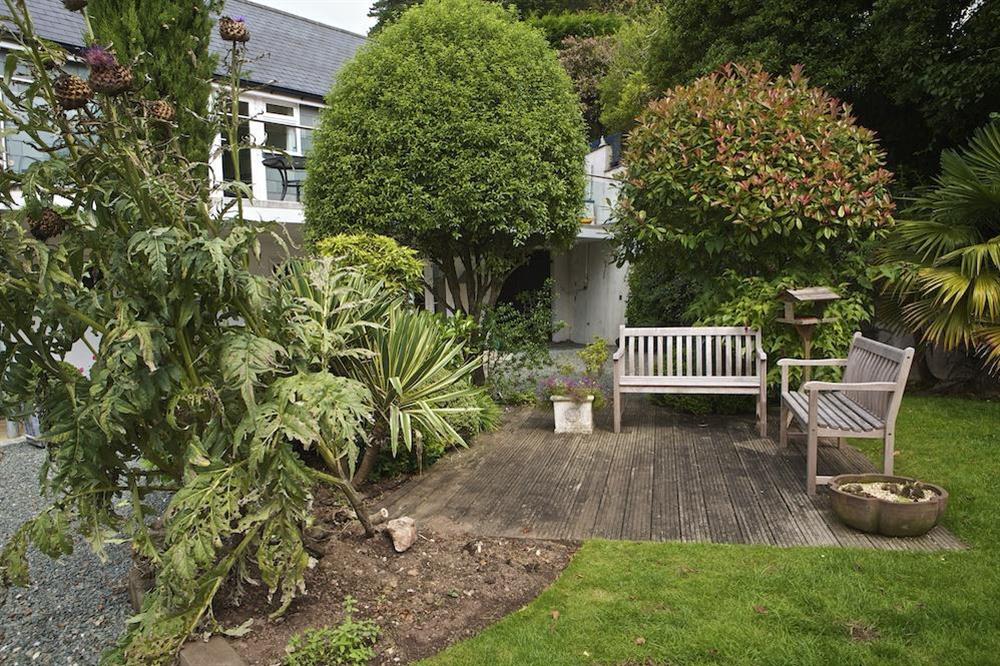 Landscaped front garden with wood-decked sitting area at St Elmo Lodge in Sandhills Road, Salcombe