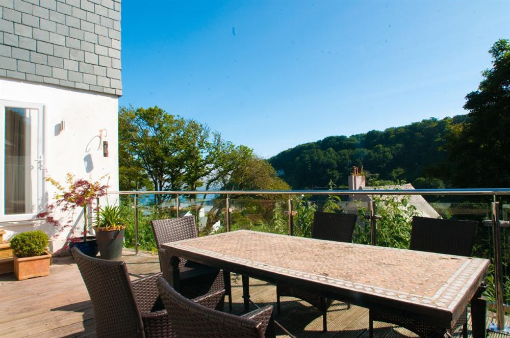 Rear decked area with patio furniture looking down to North Sands at St Elmo Lodge in Sandhills Road, Salcombe