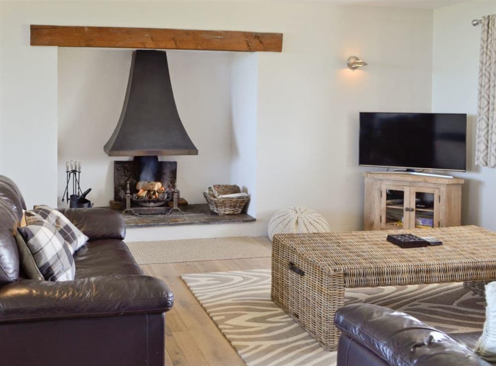 Lounge area with open-fire at St Illex in Port Isaac, Cornwall