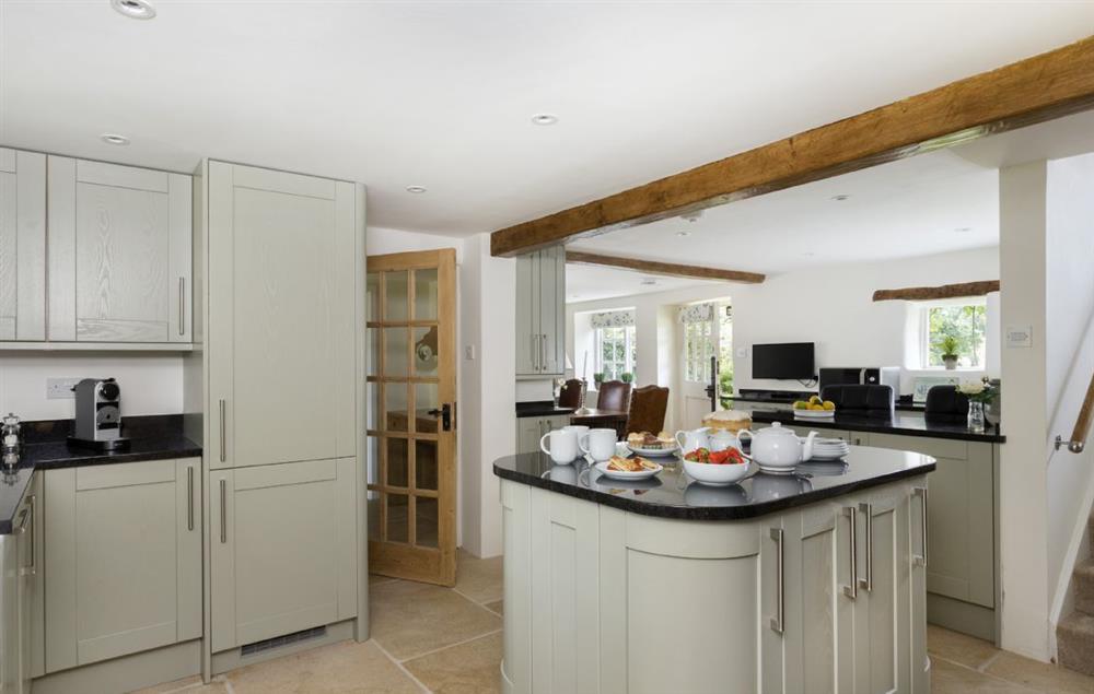 Ground floor: Kitchen with island and breakfast bar allowing for sociable cooking and entertaining at St Michaels Cottage, Broadway