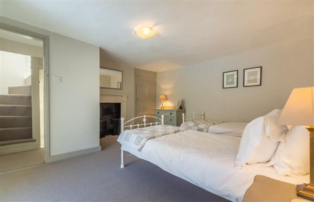 First floor: Bedroom two with two full-size single beds at St Michaels Cottage, Wells-next-the-Sea