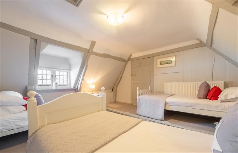 Second floor: Bedroom four with three single beds (photo 3) at St Michaels Cottage, Wells-next-the-Sea