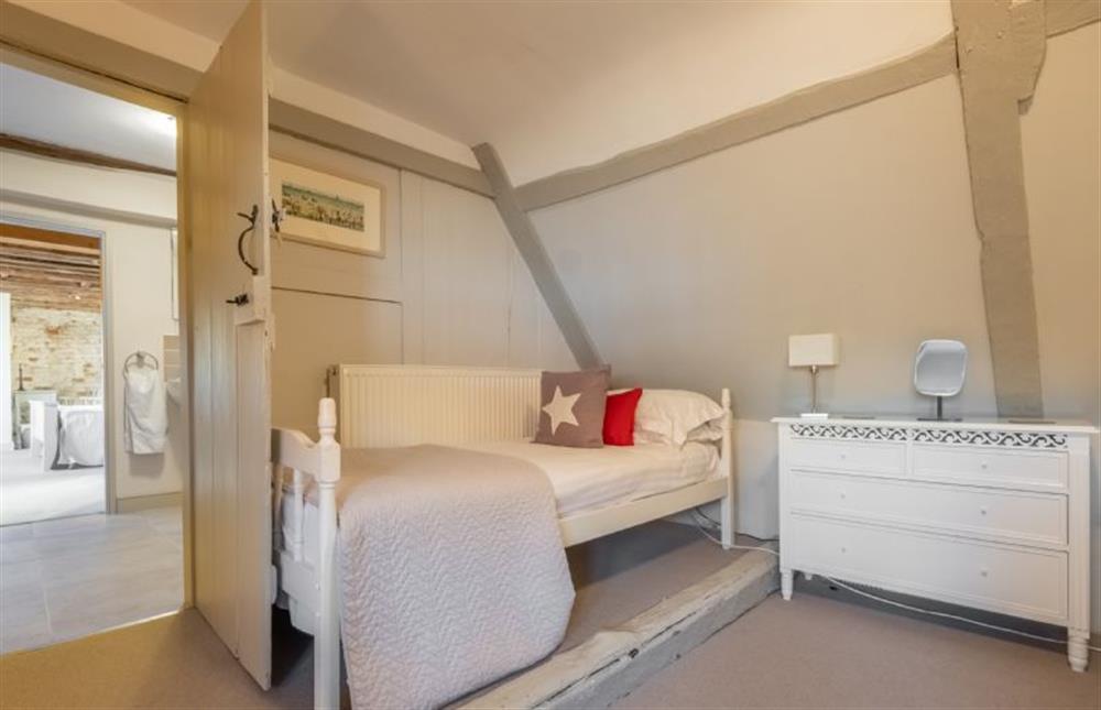 Second floor: Bedroom four with three single beds at St Michaels Cottage, Wells-next-the-Sea