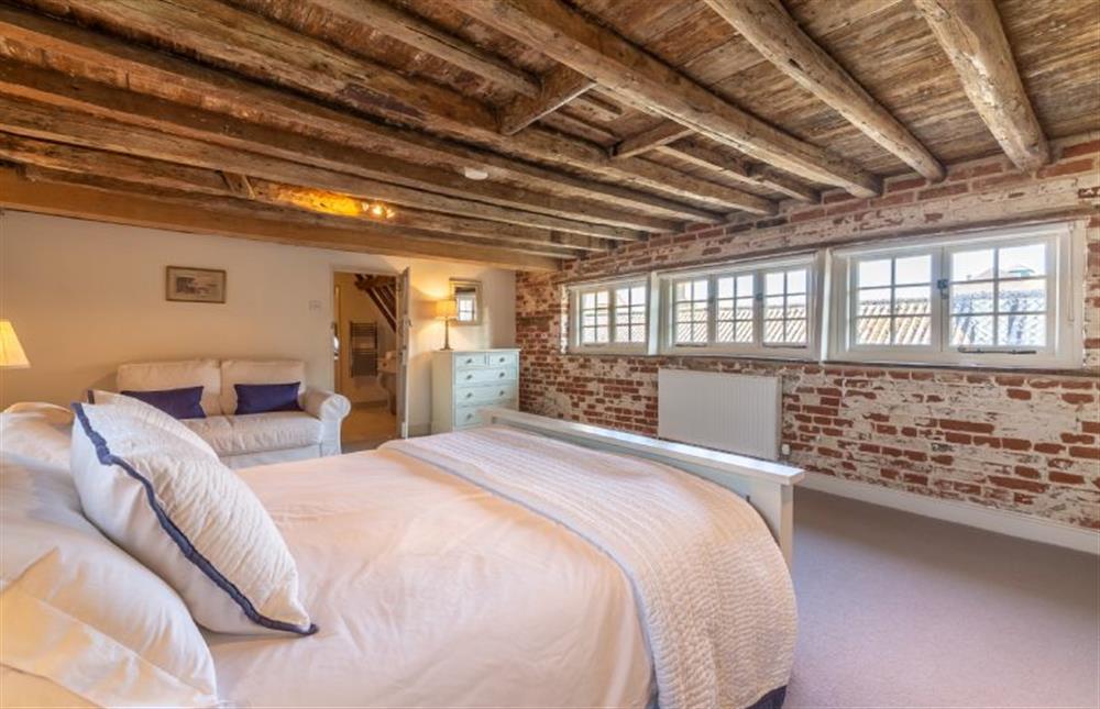 Second floor: Master bedroom has its original beams and brickwork at St Michaels Cottage, Wells-next-the-Sea