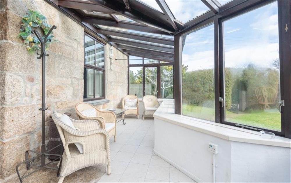 Spacious Conservatory with seating overlooking the garden. at St Michaels Farmhouse in Penzance