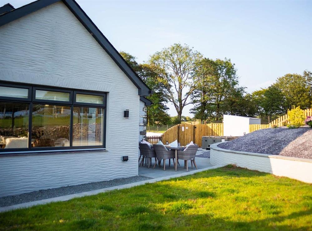 Outdoor lawned area and paved patio with furniture at Stabl in Bethania, near Aberaeron, Cardigan, Dyfed