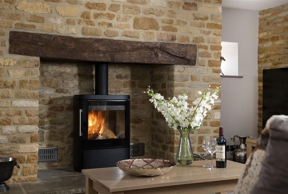 Ground floor: Sitting room with cosy wood burning stove at Stable Barn, Little Rissington