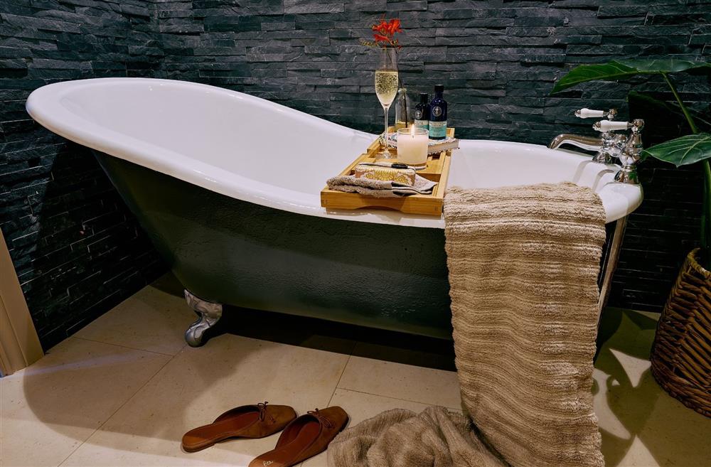 A free-standing bath with a glass of champagne