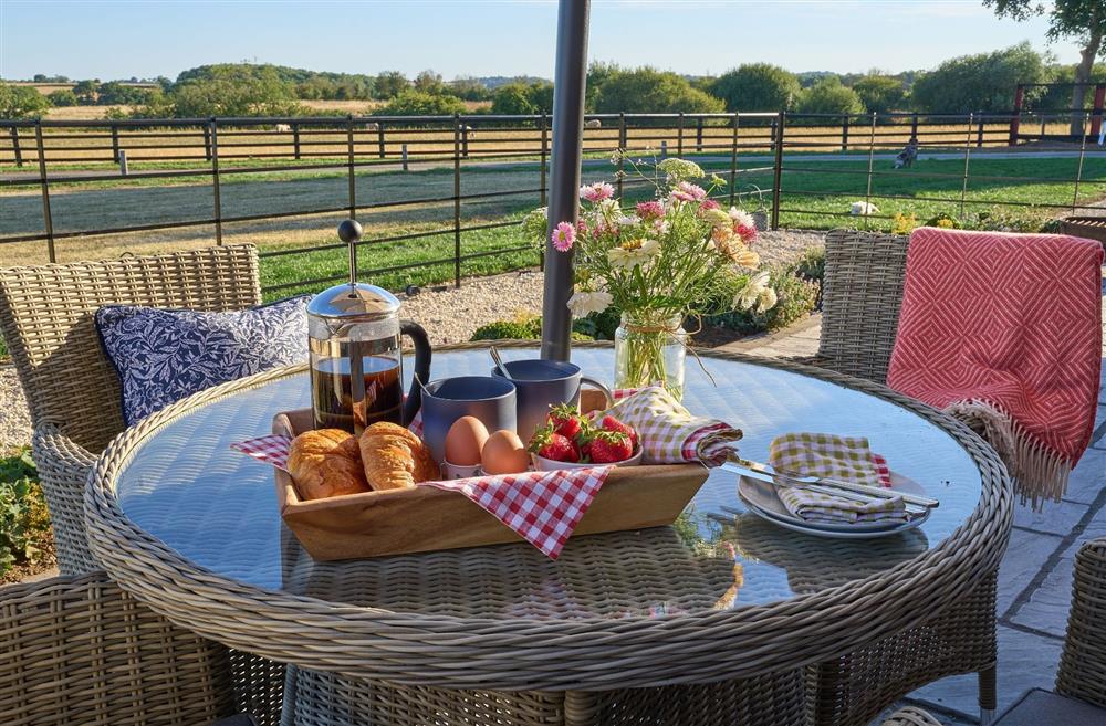 The outdoor rattan table and chairs with a hamper