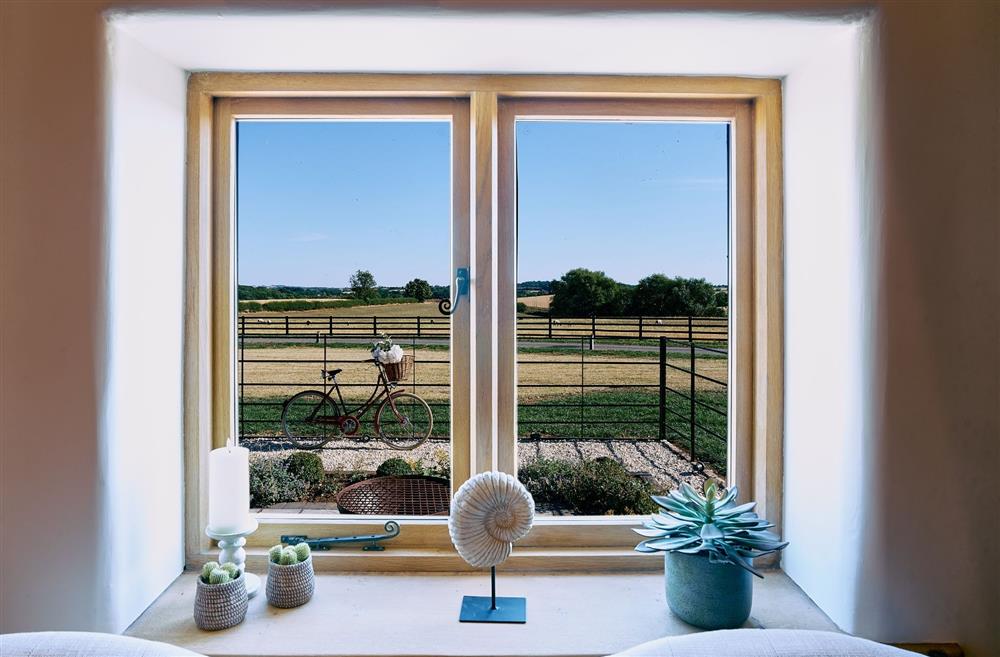 The view of a Pashley bicycle and the field beyond from the front window of Stable Barn