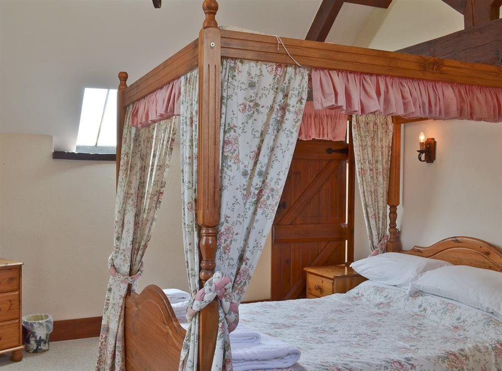 Four poster bedroom at Stable Cottage in Colyford, near Seaton, Devon