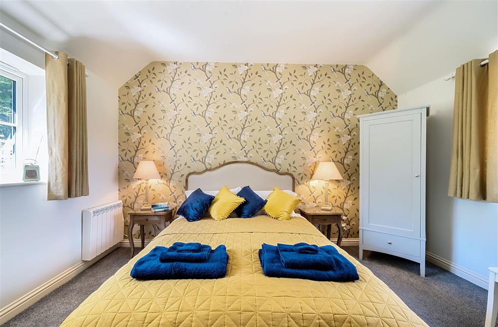 The bedroom has double aspect windows, allowing the light to flood in at Stable Cottage, Dorchester