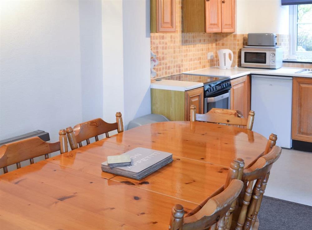 Dining area and adjacent kitchen at Stable Cottage in Gulval, near Penzance, Cornwall