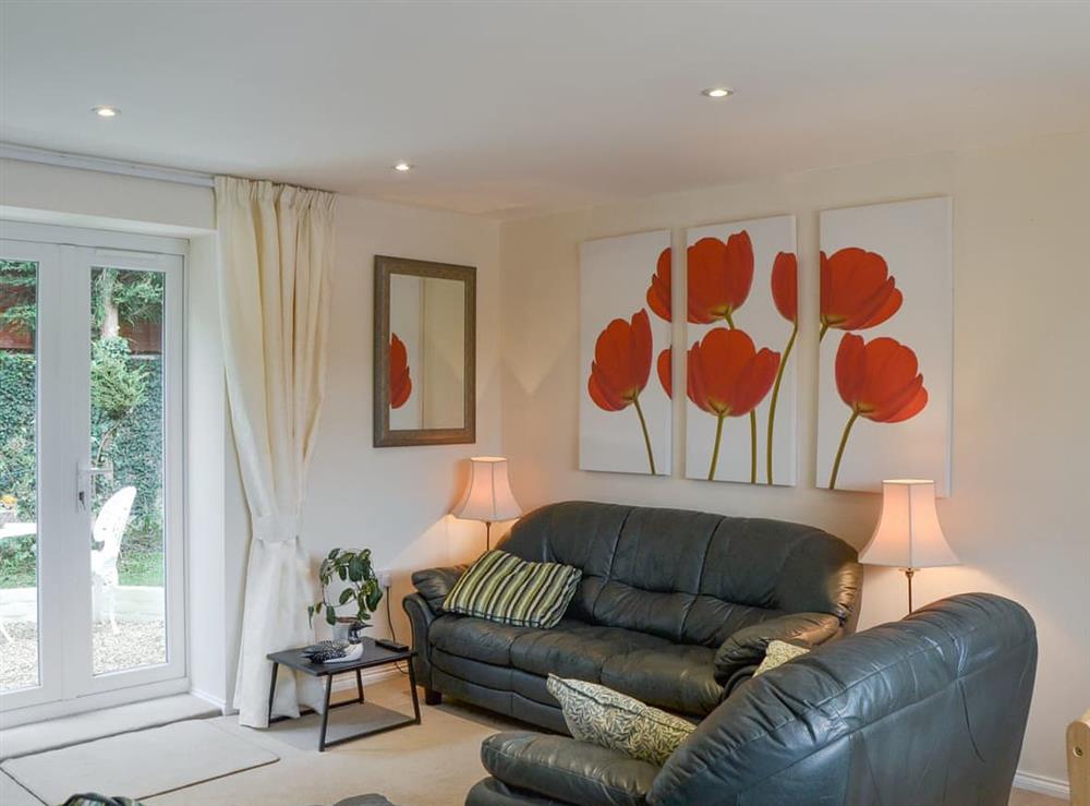 Attractive living area with French doors to patio area at Stable Cottage in Gunville, near Newport, Isle of Wight