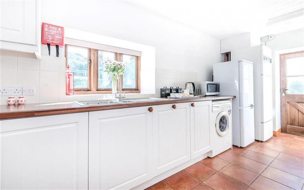 The kitchen with access to the garden at Stable Cottage in Honiton