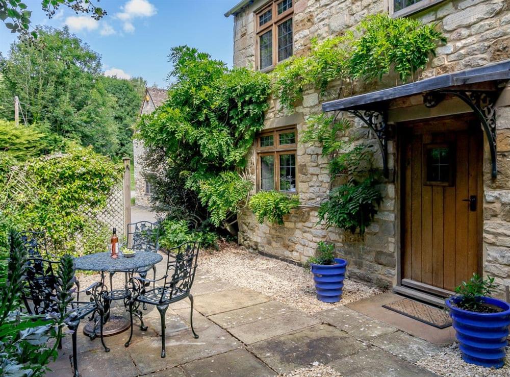 Paved patio area with outdoor furniture at Stable Cottage in Uley, near Dursley, Gloucestershire