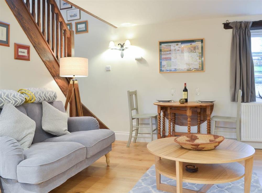 Comfortable living area and open staircase at Stable End in Stickle Path, near Watchet, Somerset
