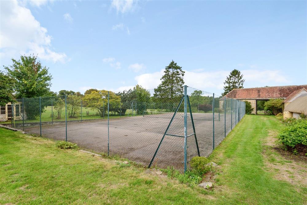 The tennis court (bookable via the owners) at Stable House, Clifton Maybank, nr Sherborne