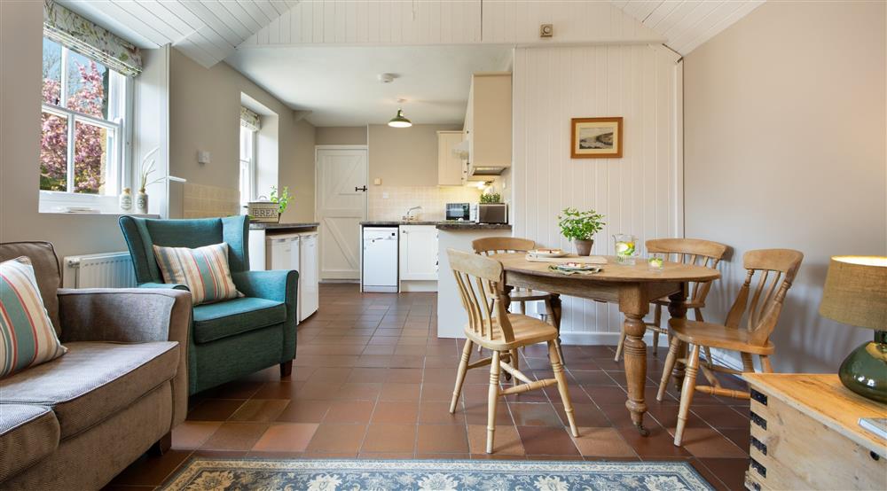 The kitchen, dining and sitting room at Stackpole Dairy Cottage in Pembroke, Pembrokeshire